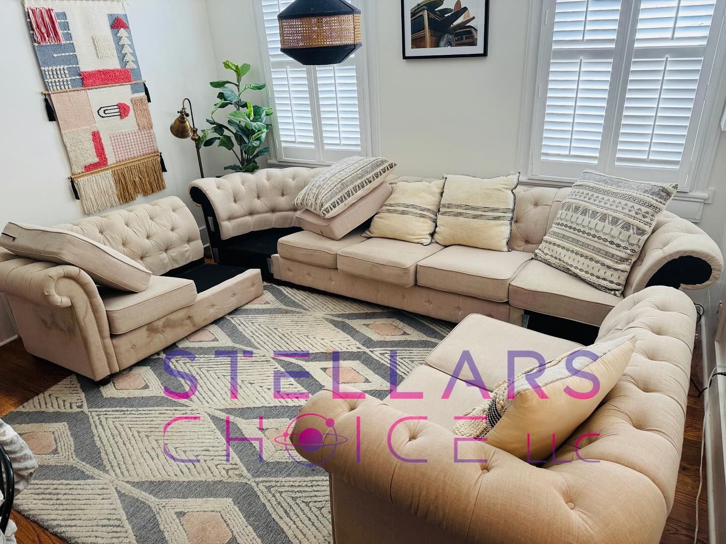 Beige tufted sofa set in a living room with patterned rug.