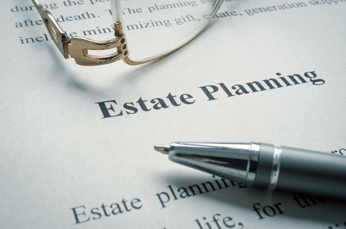 A pen is sitting on top of a piece of paper that says estate planning