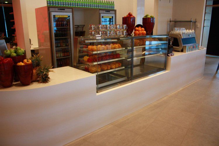 white solid surface restaurant counter with food