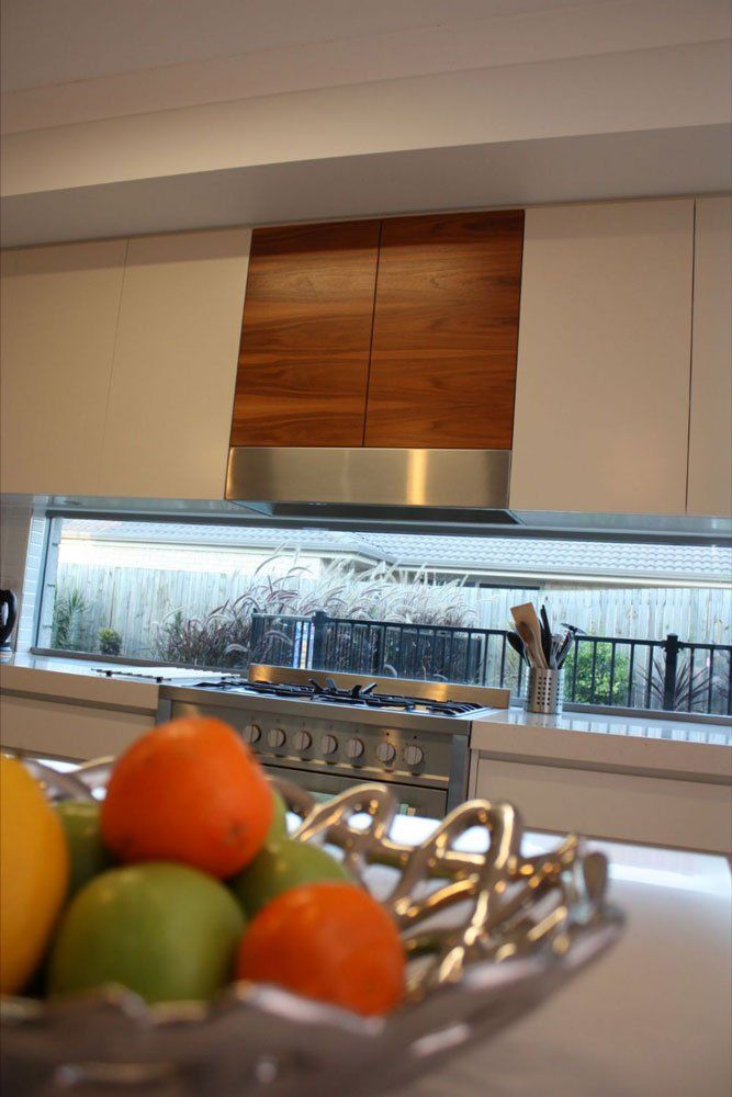 modern kitchen with solid surface counter tops and fruit