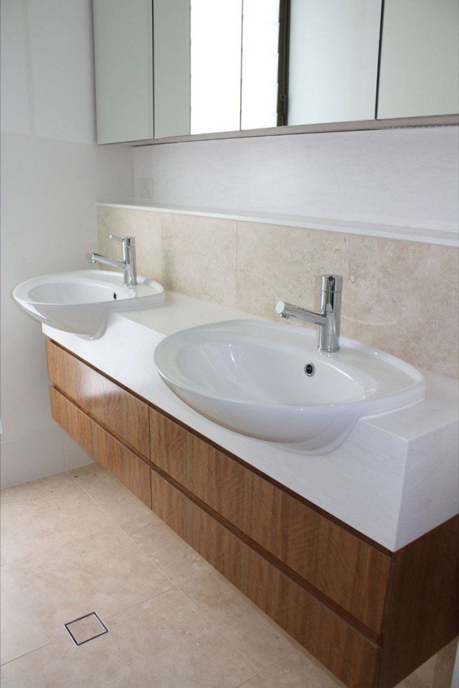 solid surface counter tops in bathroom with two sinks