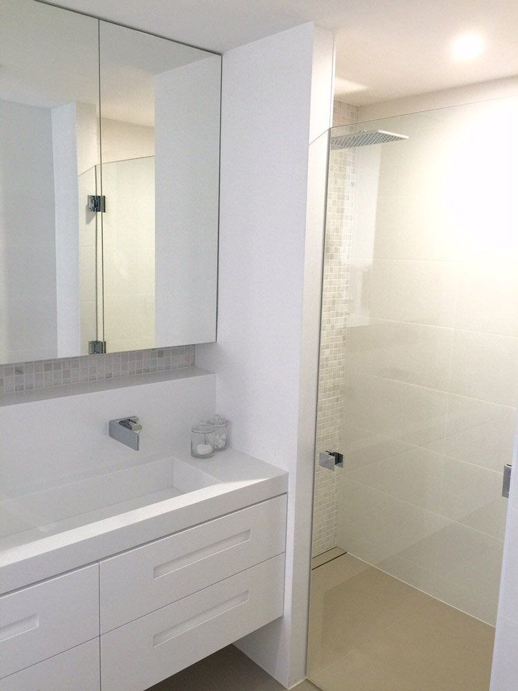 white solid surface counter tops in bathroom with mirror