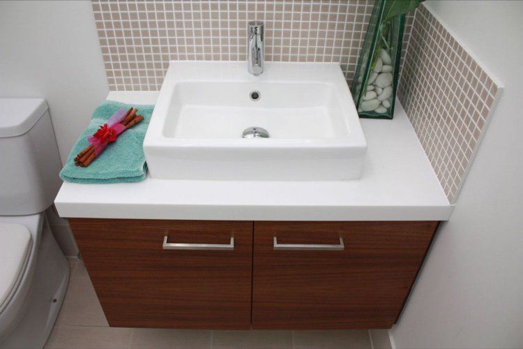 white solid surface bathroom sink with blue towel