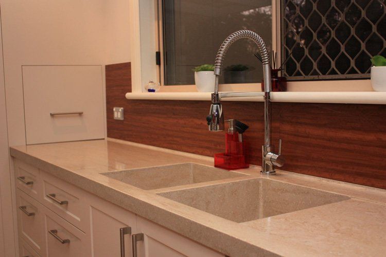 sink in kitchen with solid surface counter