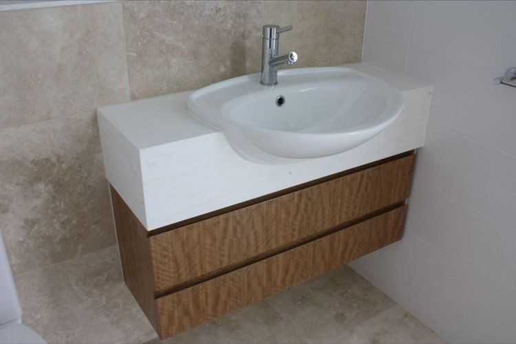 white solid surface bathroom overhanging sink