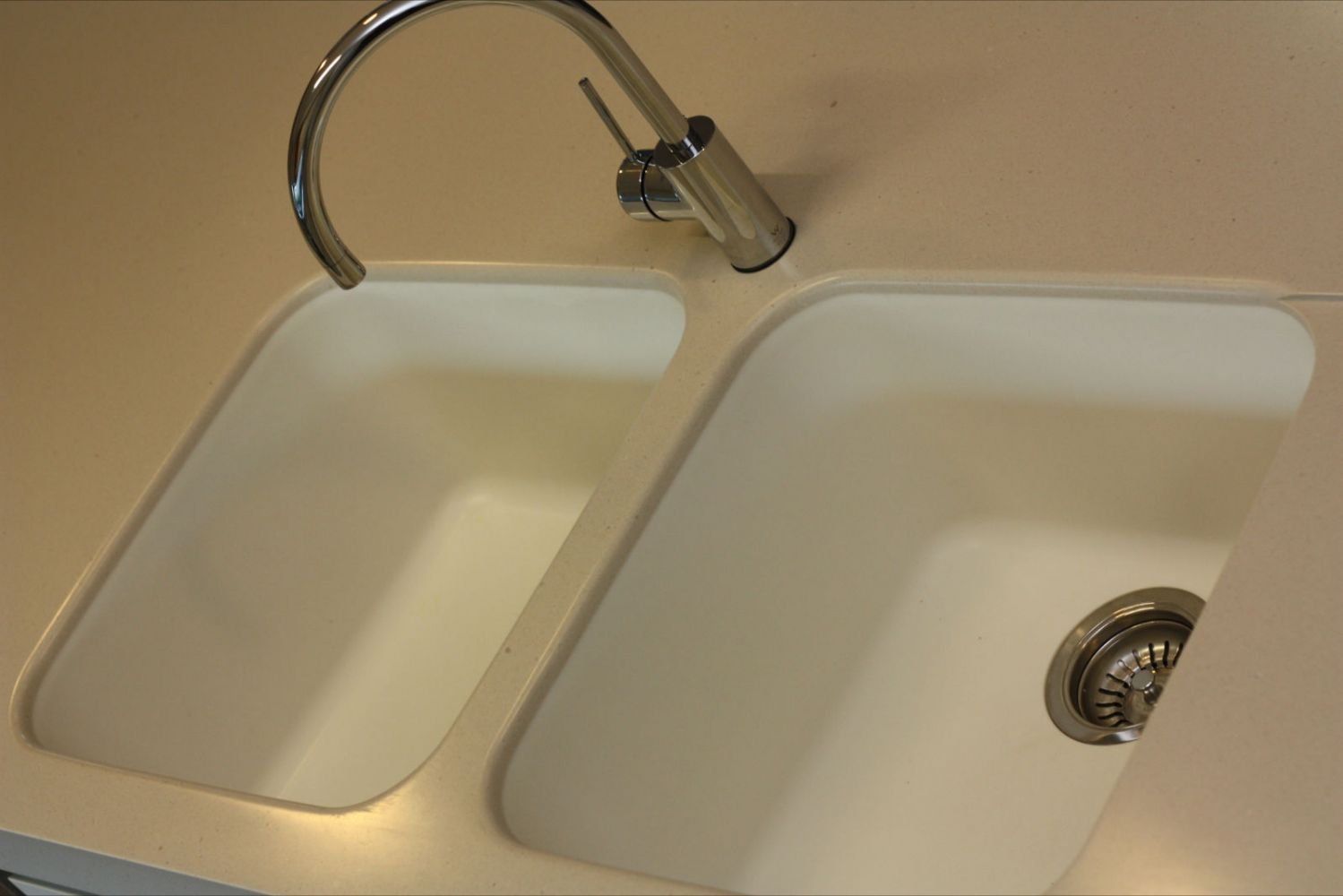 solid surface kitchen sink with stainless steel faucet
