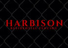 Harbison Residential Fencing logo on black chain link background in red font.