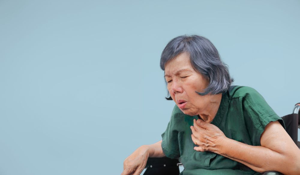 Elder women choking in a wheelchair