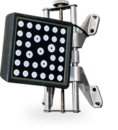A wheel alignment sensor target with a black panel containing a grid of white circular markers, mounted on a metal frame. | Smithwest Service Center