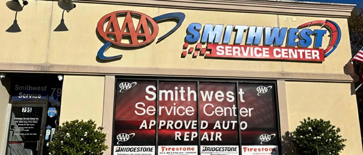 The Smithwest Service Center building with a large AAA logo and Approved Auto Repair signage on the windows. | Smithwest Service Center