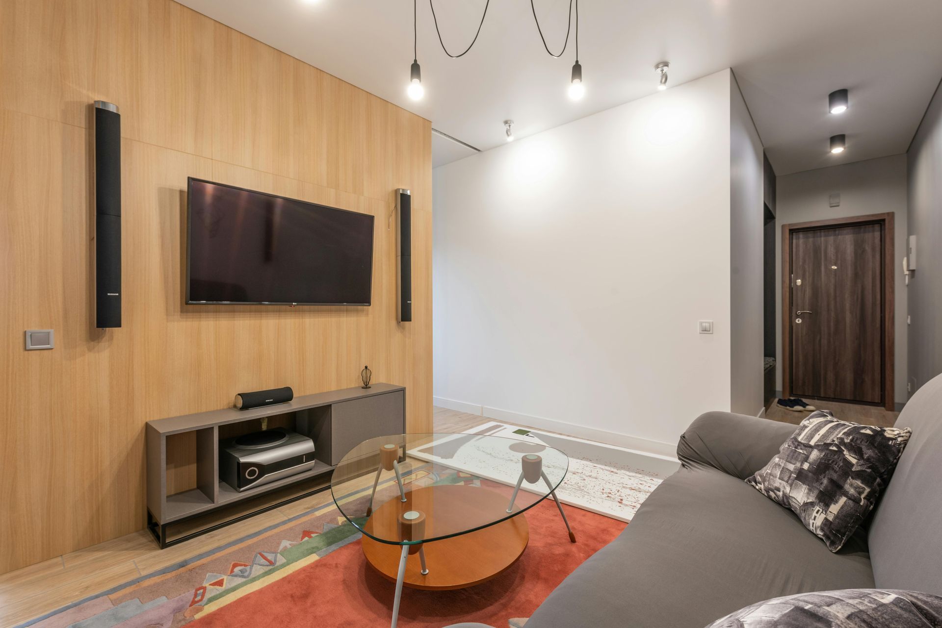 A living room with a couch , television , and coffee table.