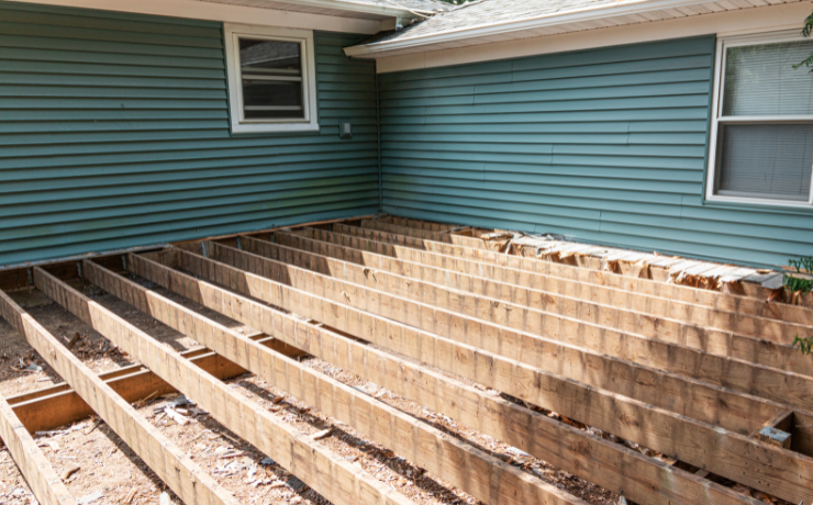 A photo of a deck in the process of being built. The deck frame is built. It still needs deck boards and a railing installed.