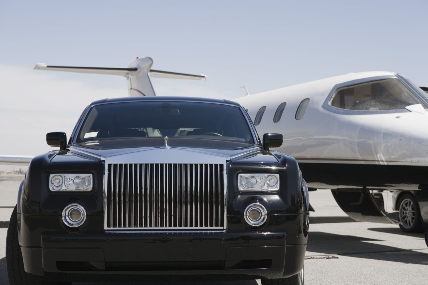 Airport Transportation — Black Limo and An Airplane in Pensacola, FL