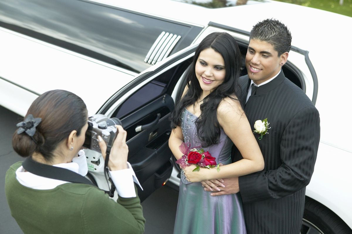 Proms — Mother Taking Picture of Two Couple in Front of a Limo For Their Prom in Pensacola, FL