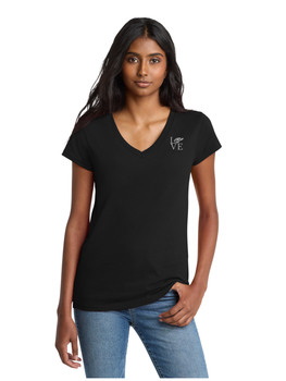 Woman wearing a black v-neck t-shirt and blue jeans, standing in front of a white background.