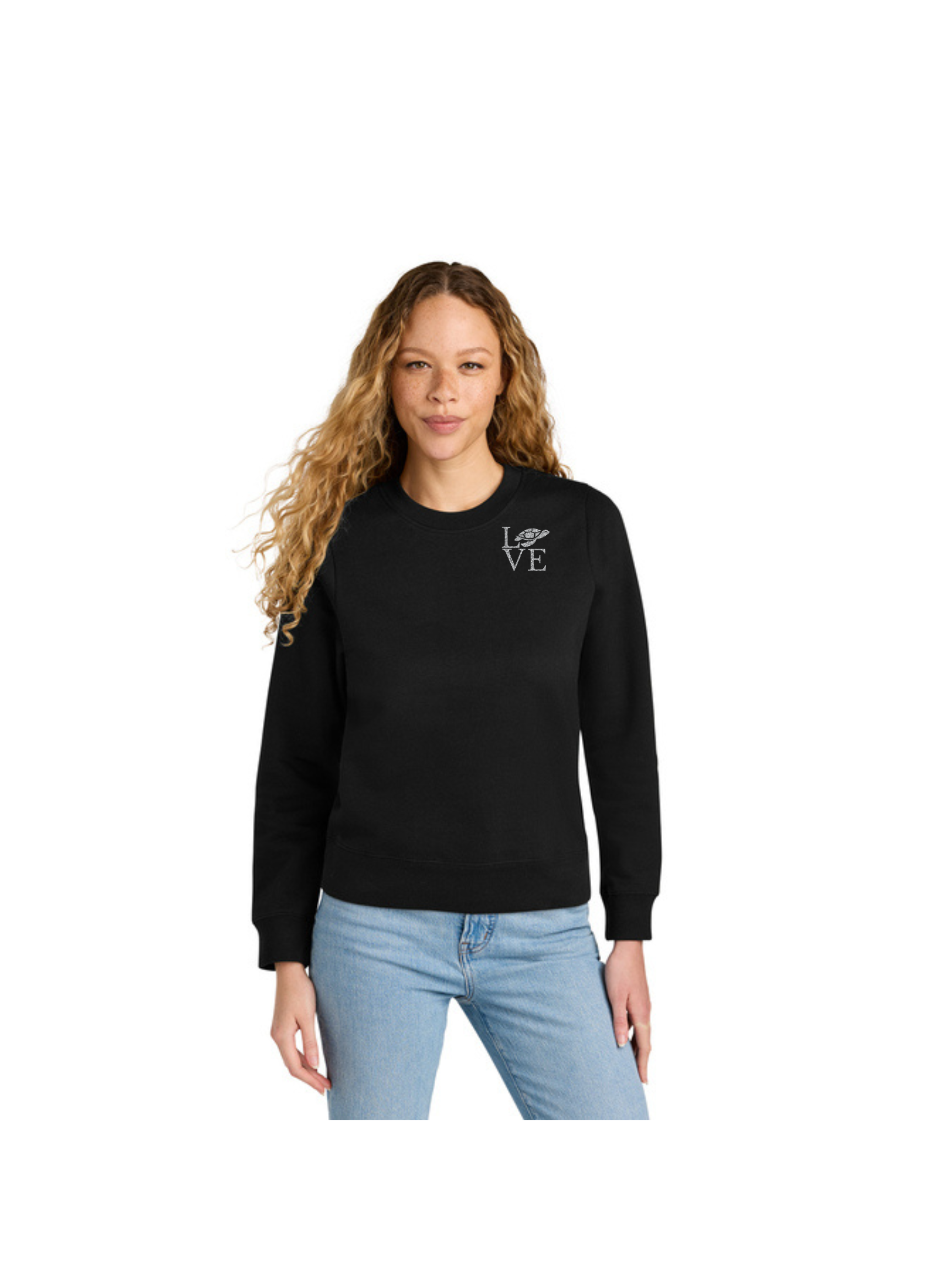 Woman wearing a black sweatshirt and jeans, standing against a white backdrop.