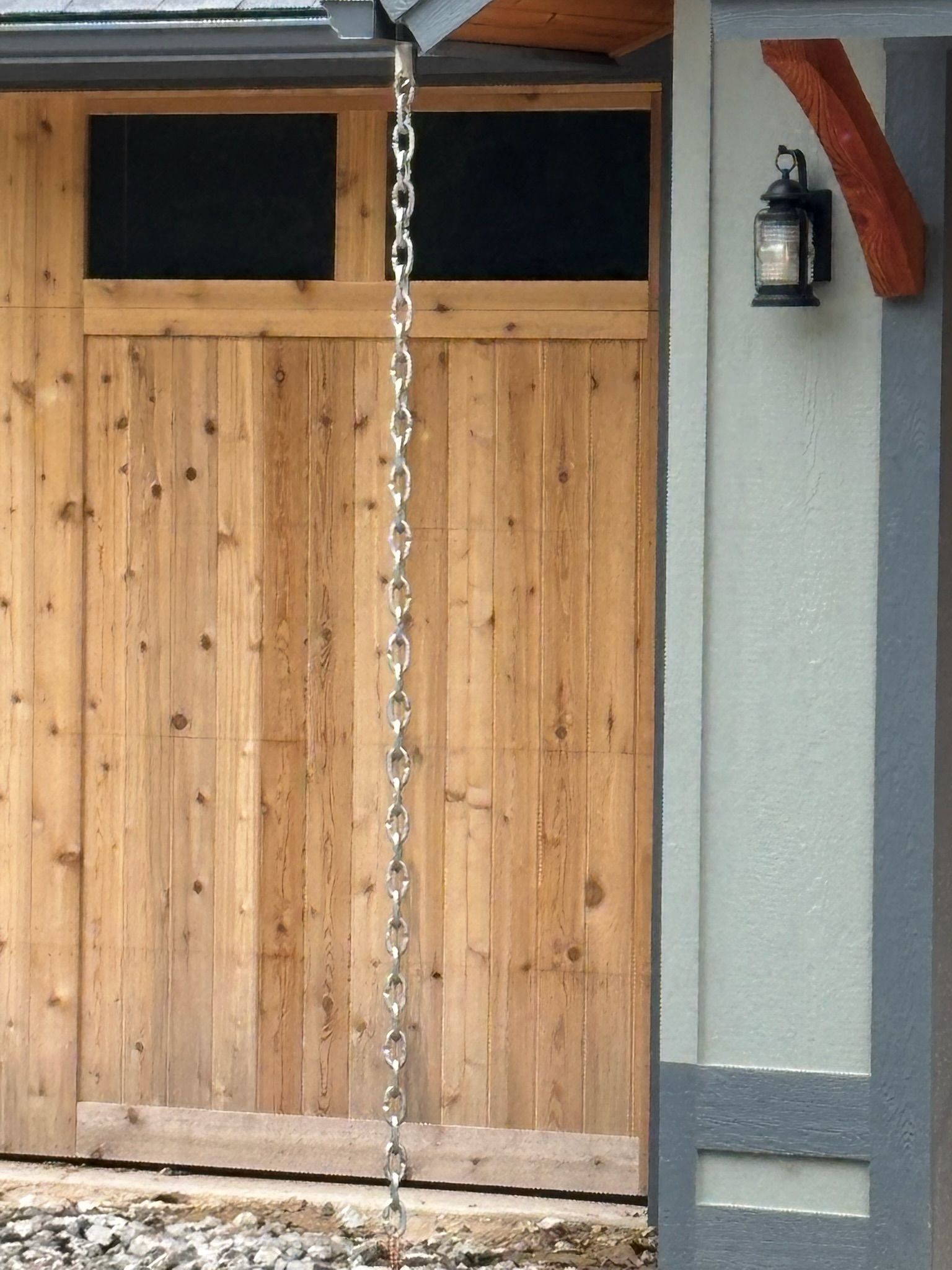 A potted plant is sitting on a sidewalk next to a house.
