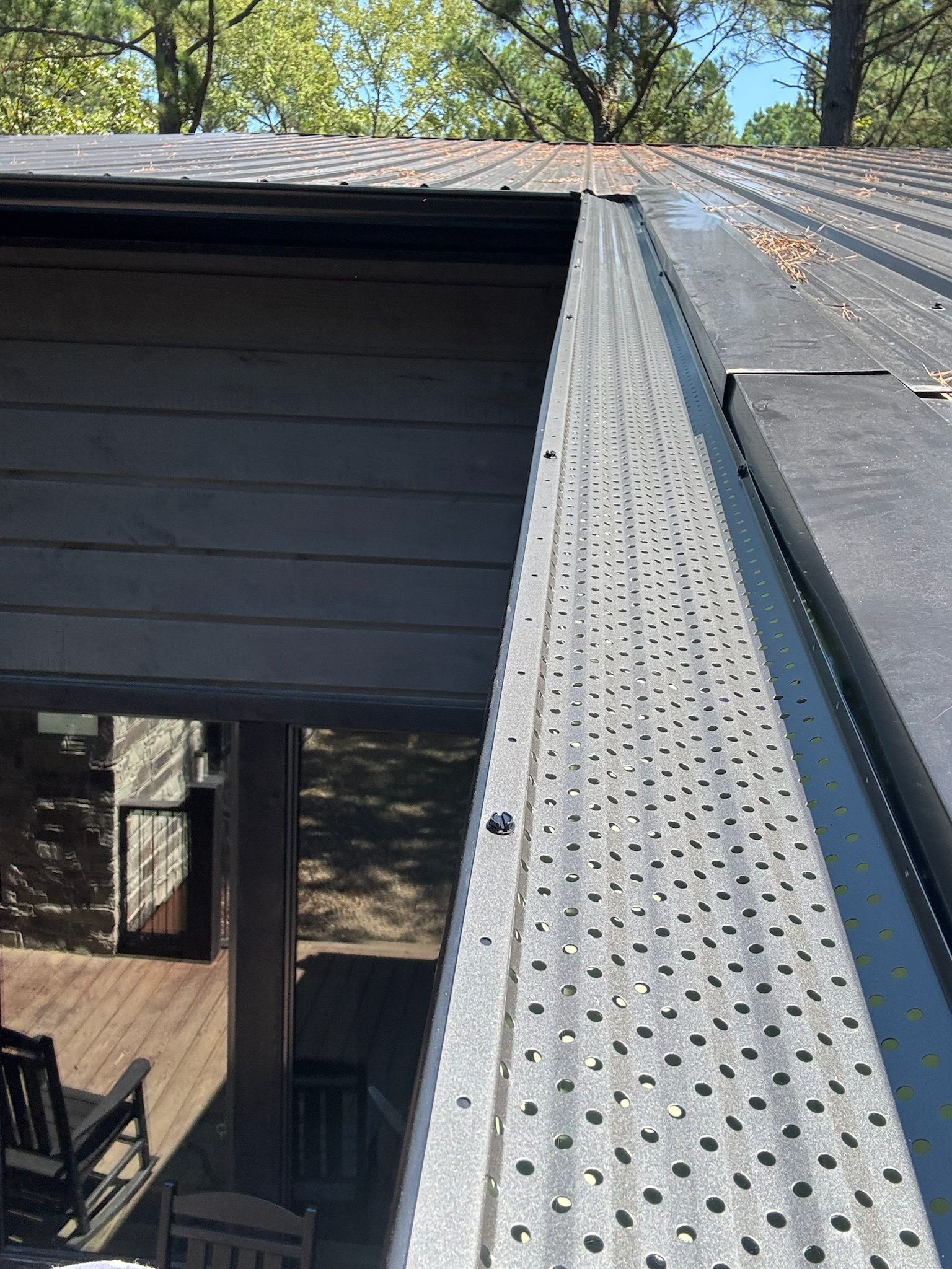 A close up of a roof with a gutter on it.