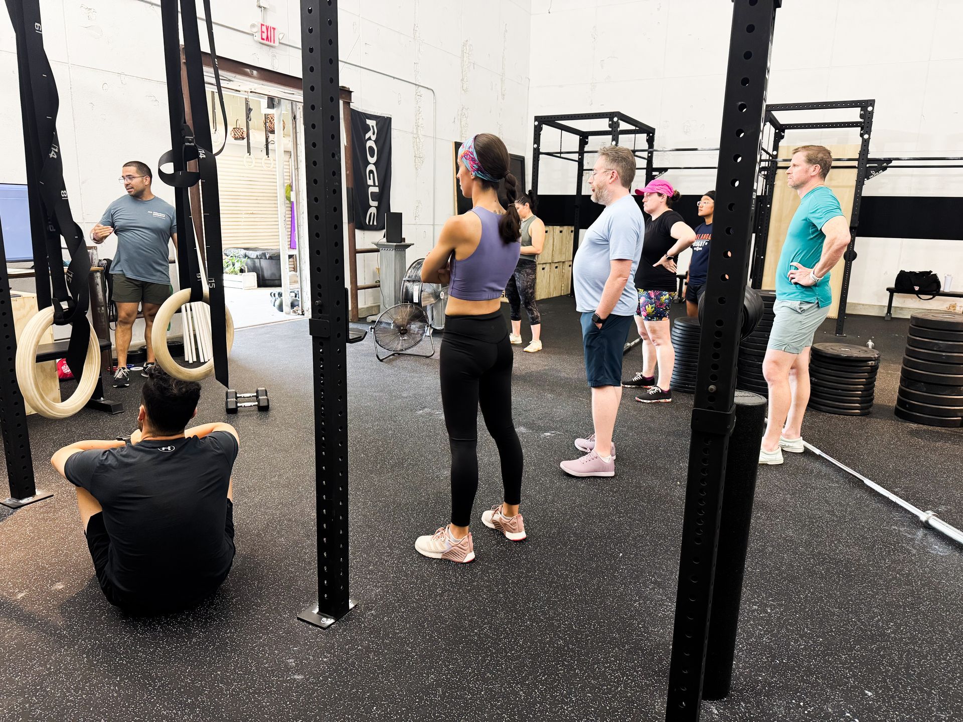 Inclusive CrossFit gym in Winter Park FL with members gathered around the instructor for a group workout, showing beginner-friendly and community-centered training.
CrossFit Orlando.