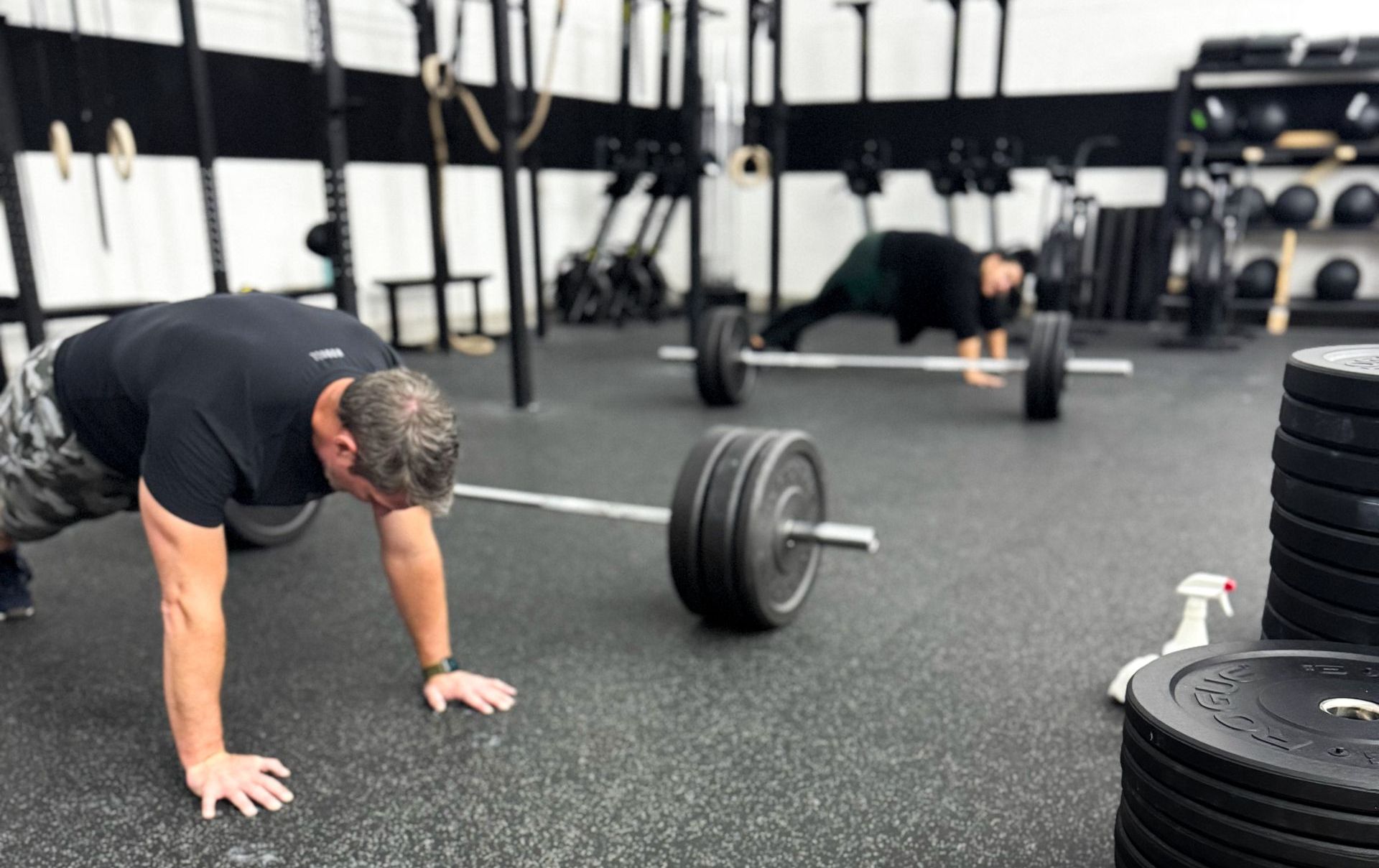 Members performing functional fitness exercises during a coached CrossFit class at an inclusive CrossFit gym in Winter Park, FL, focused on Orlando community and scalable workouts for all fitness levels.