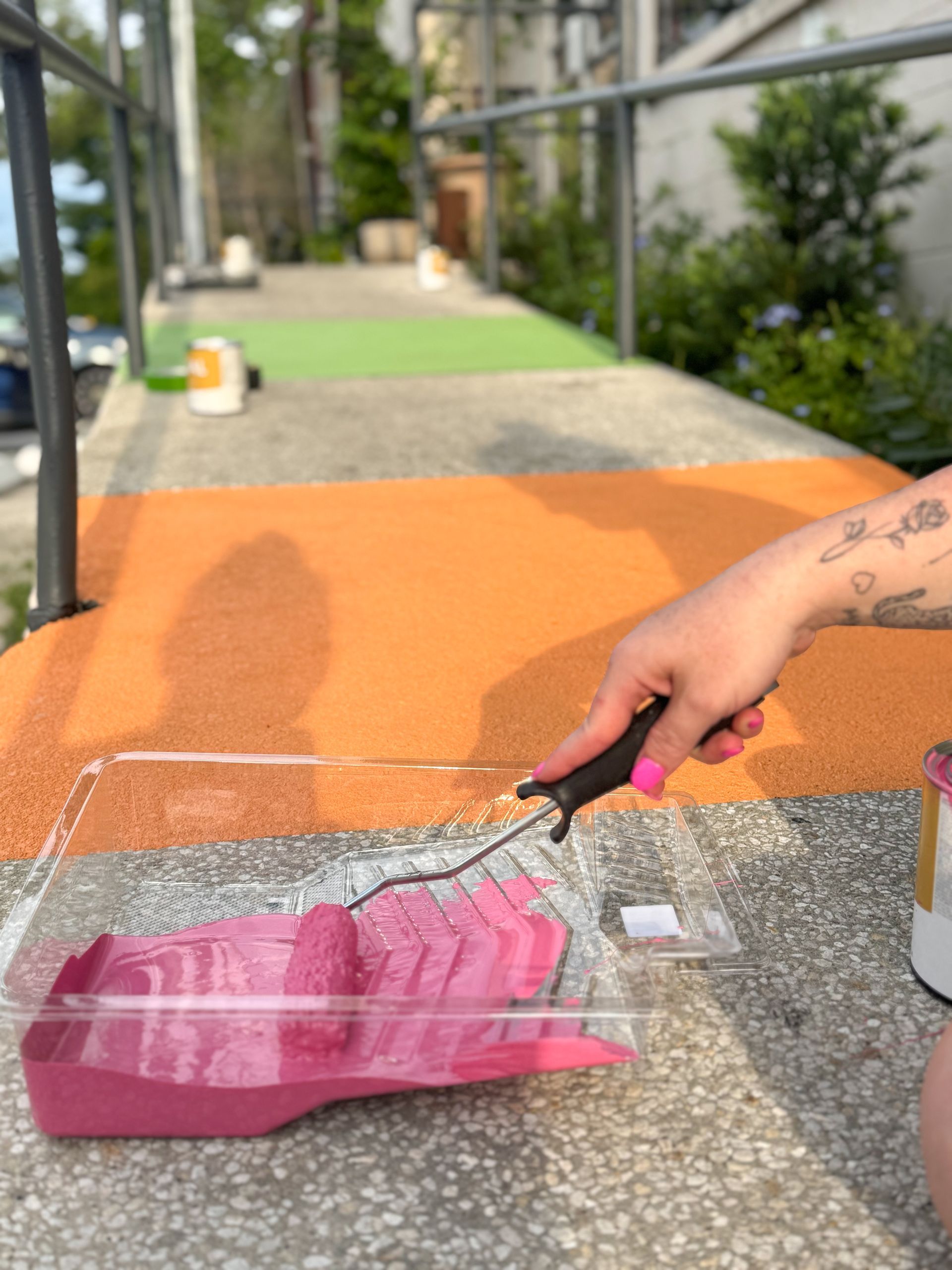 All Inclusive CrossFit and Harmon Collective owners painting a rainbow ramp in Winter Park