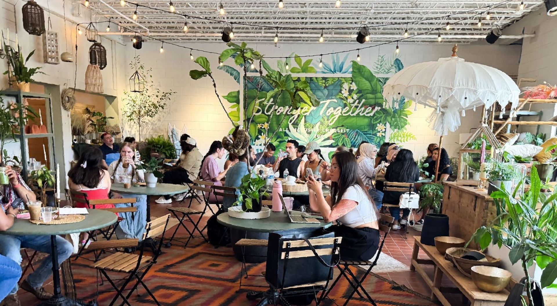 Kiwi and Fern community space in Winter Park with plants, home décor, and cozy seating