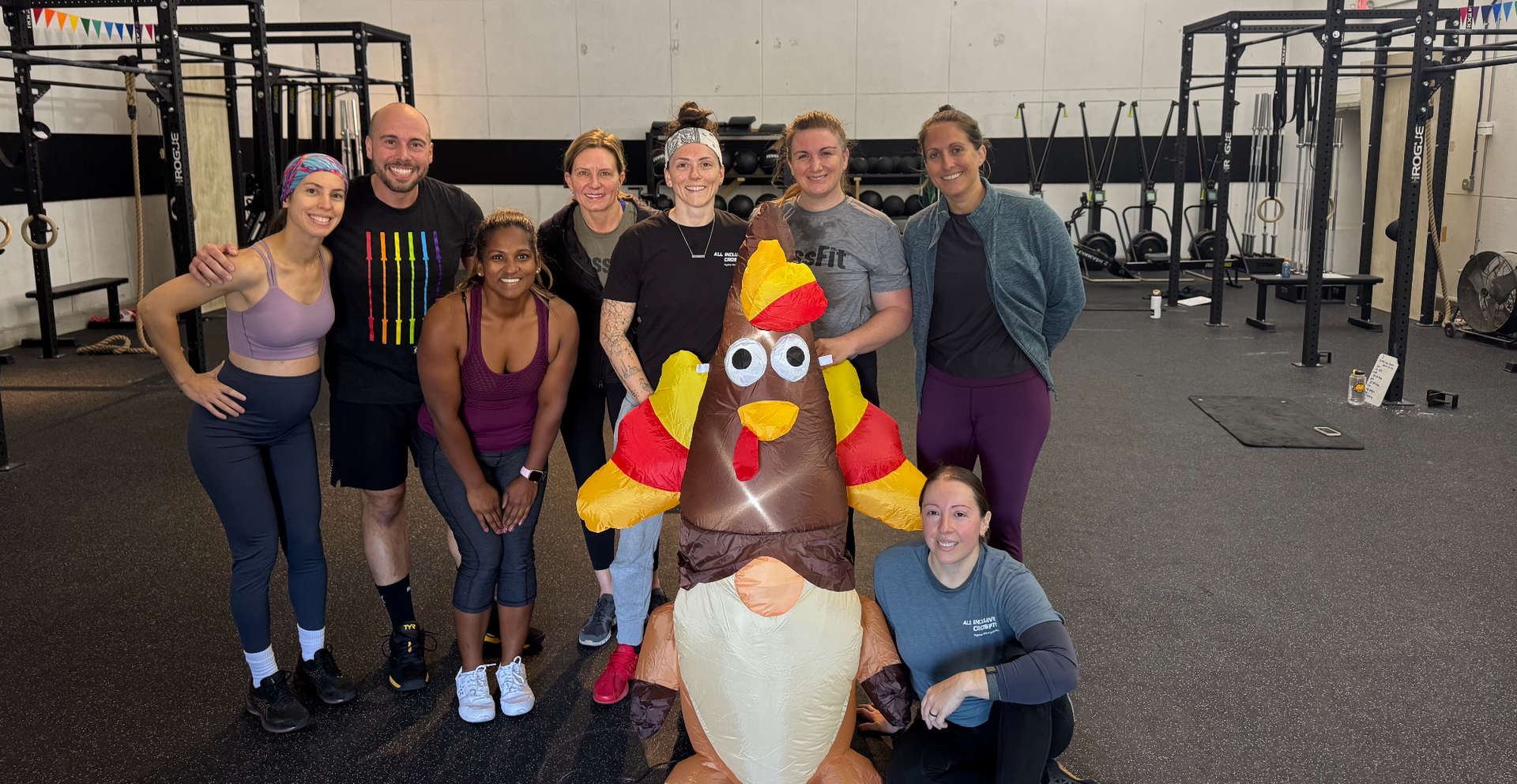 Winter Park CrossFit Gym members laughing and supporting each other during a friendly group workout