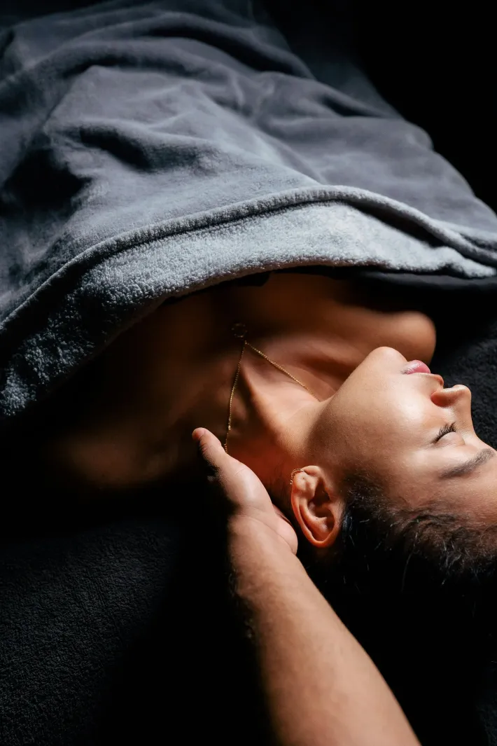 Two women are hugging each other with their eyes closed.