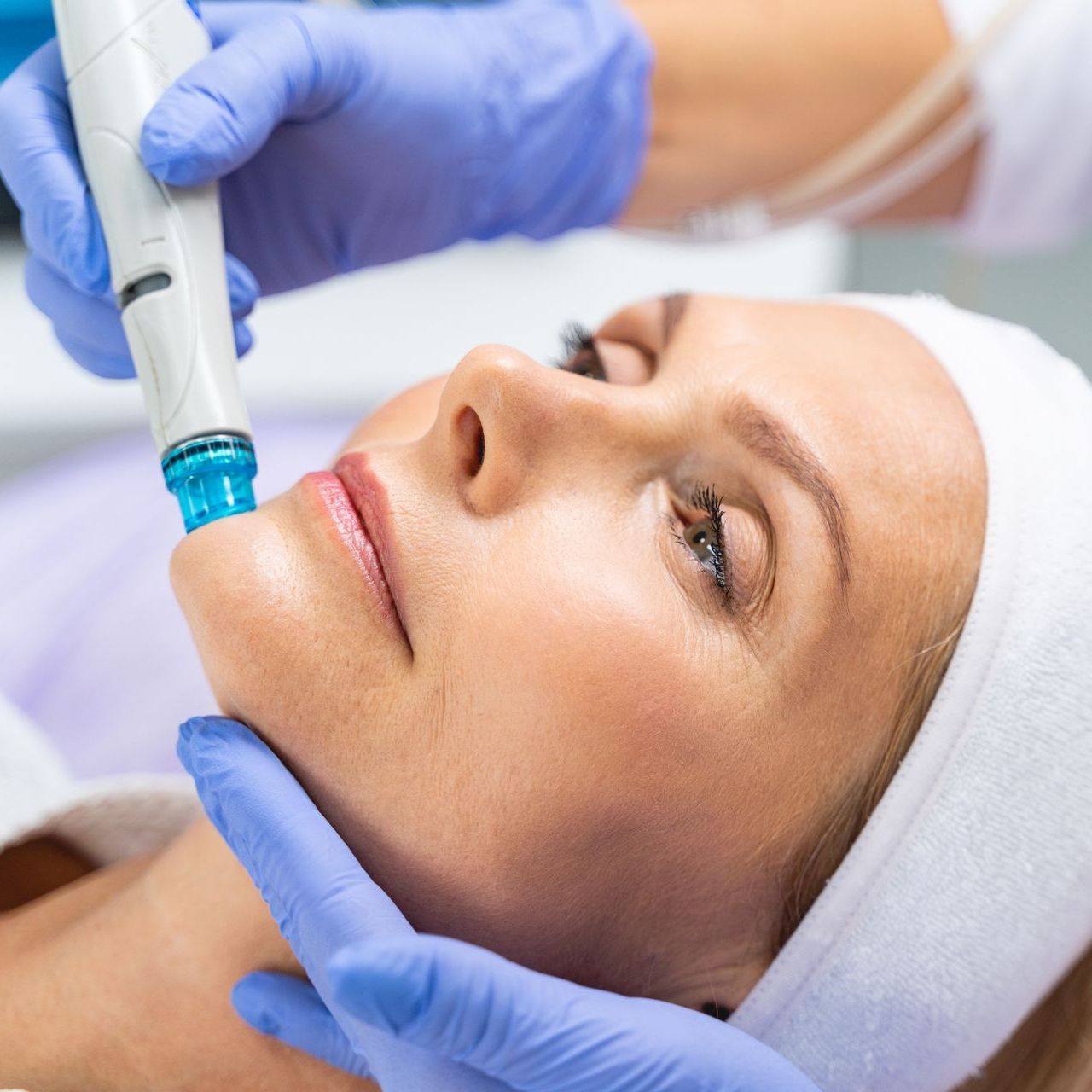 A woman is getting a facial treatment at a beauty salon.