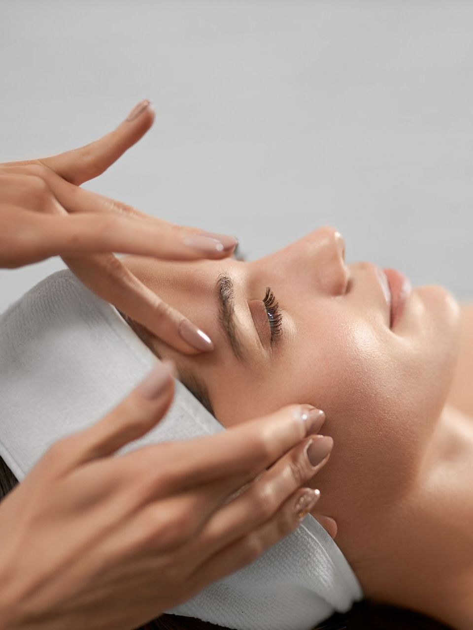 A woman is getting a facial treatment at a spa.