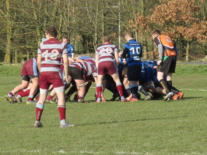 A group of rugby players with one wearing the number 10