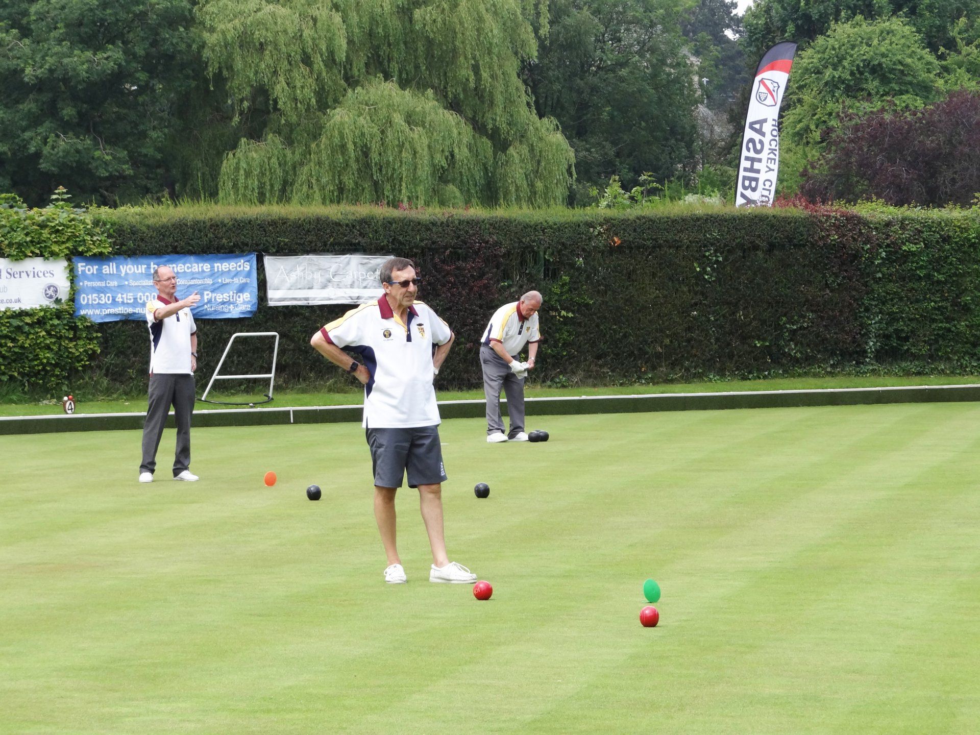 A group of men are playing a game of lawn bowling