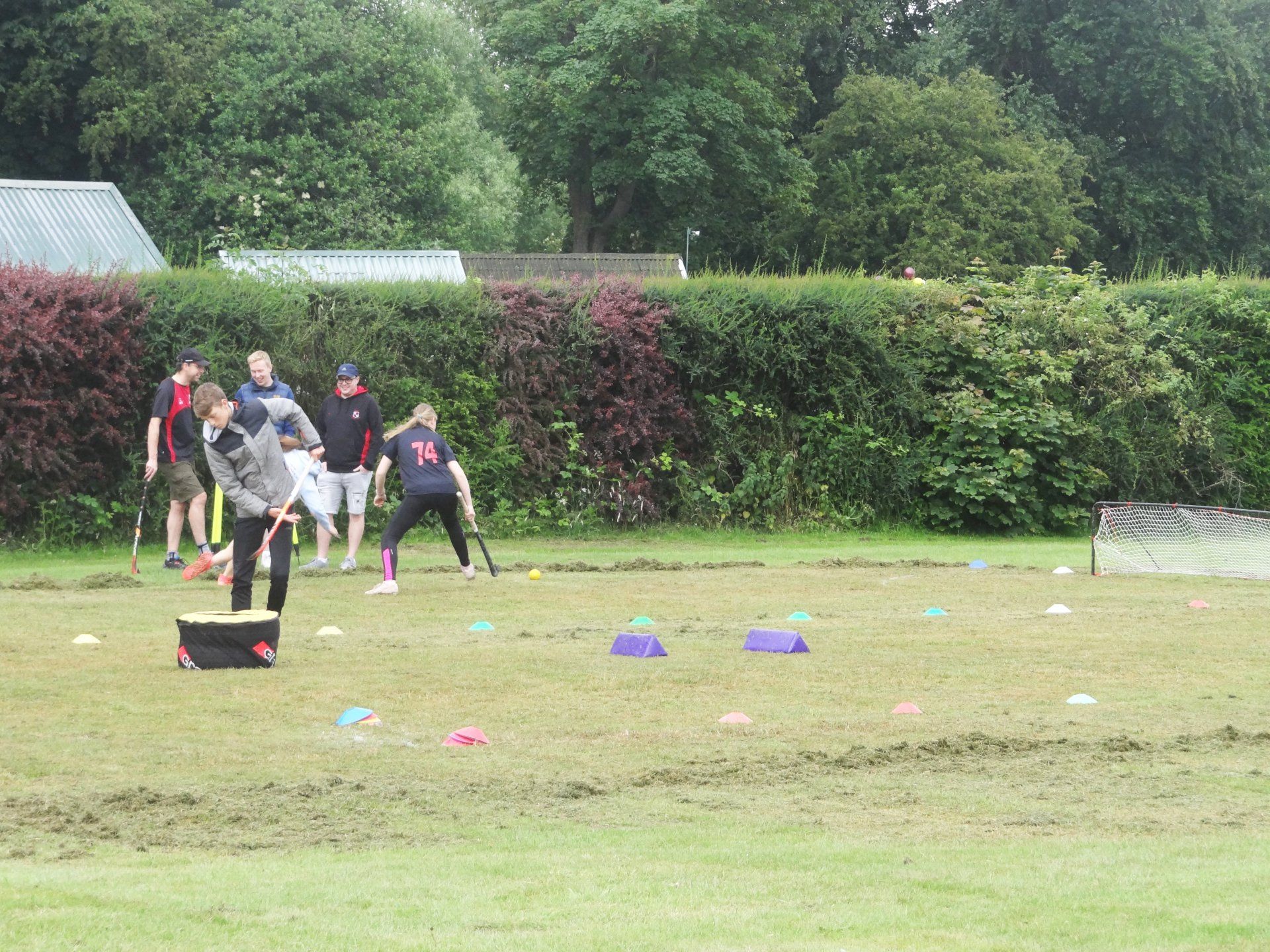 A group of people are playing a game of soccer in a field.