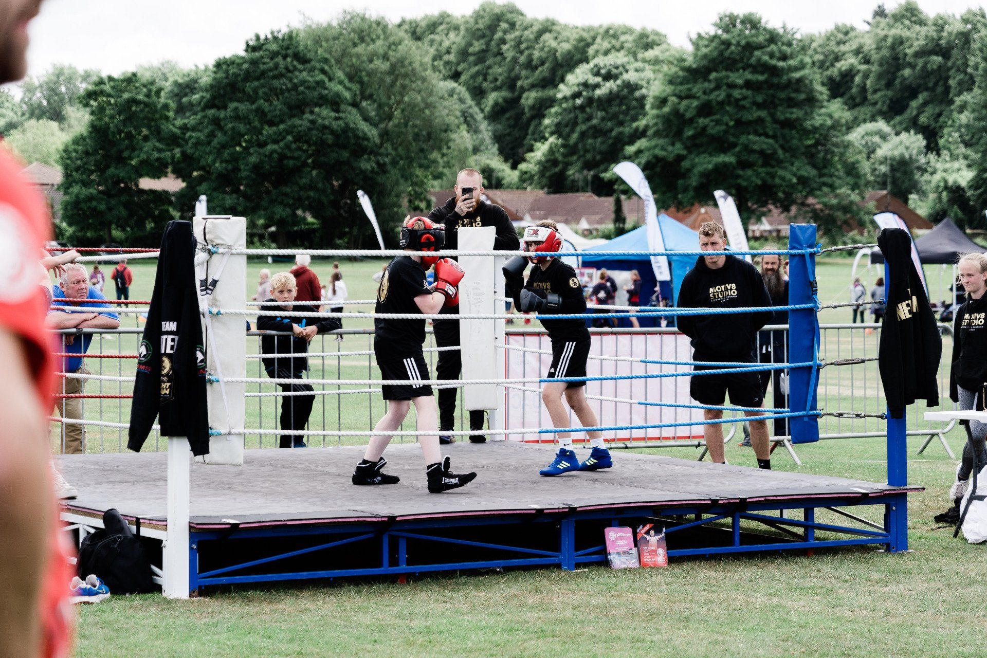 A group of people are standing in a boxing ring.