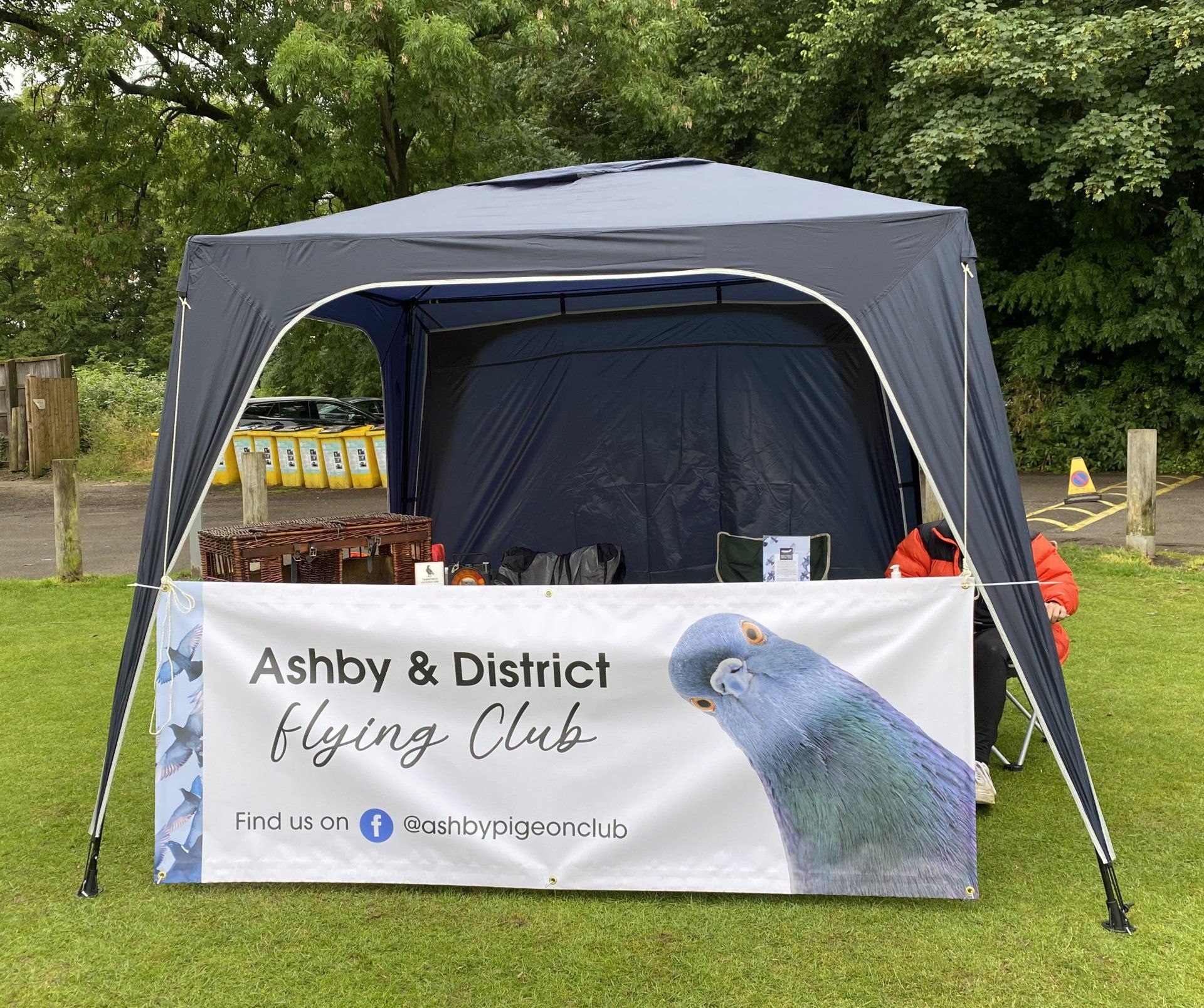 A blue tent with a sign that says ashby & district flying club