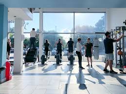 A group of people are standing in a gym.