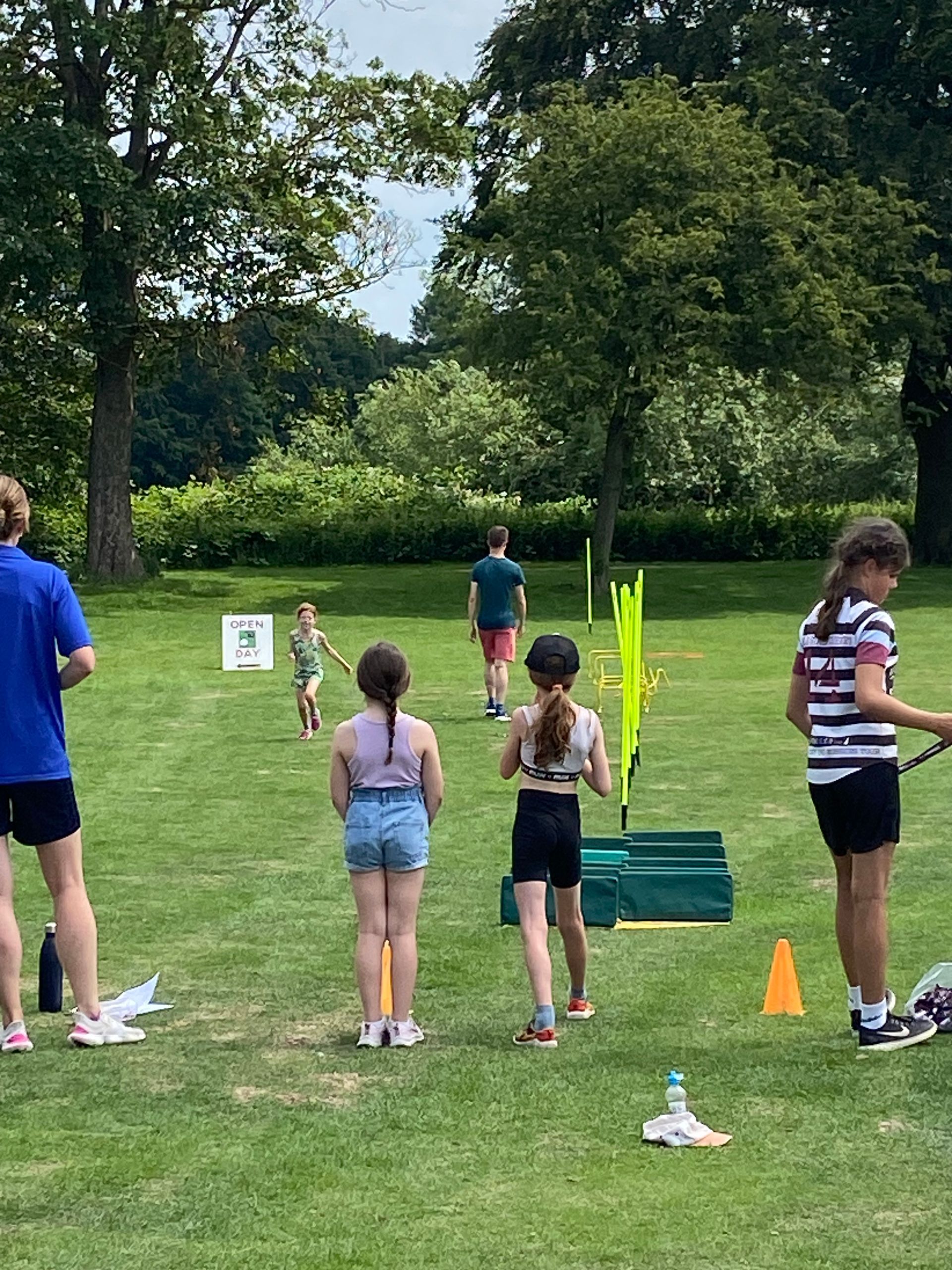 A group of children are playing a game in a park.