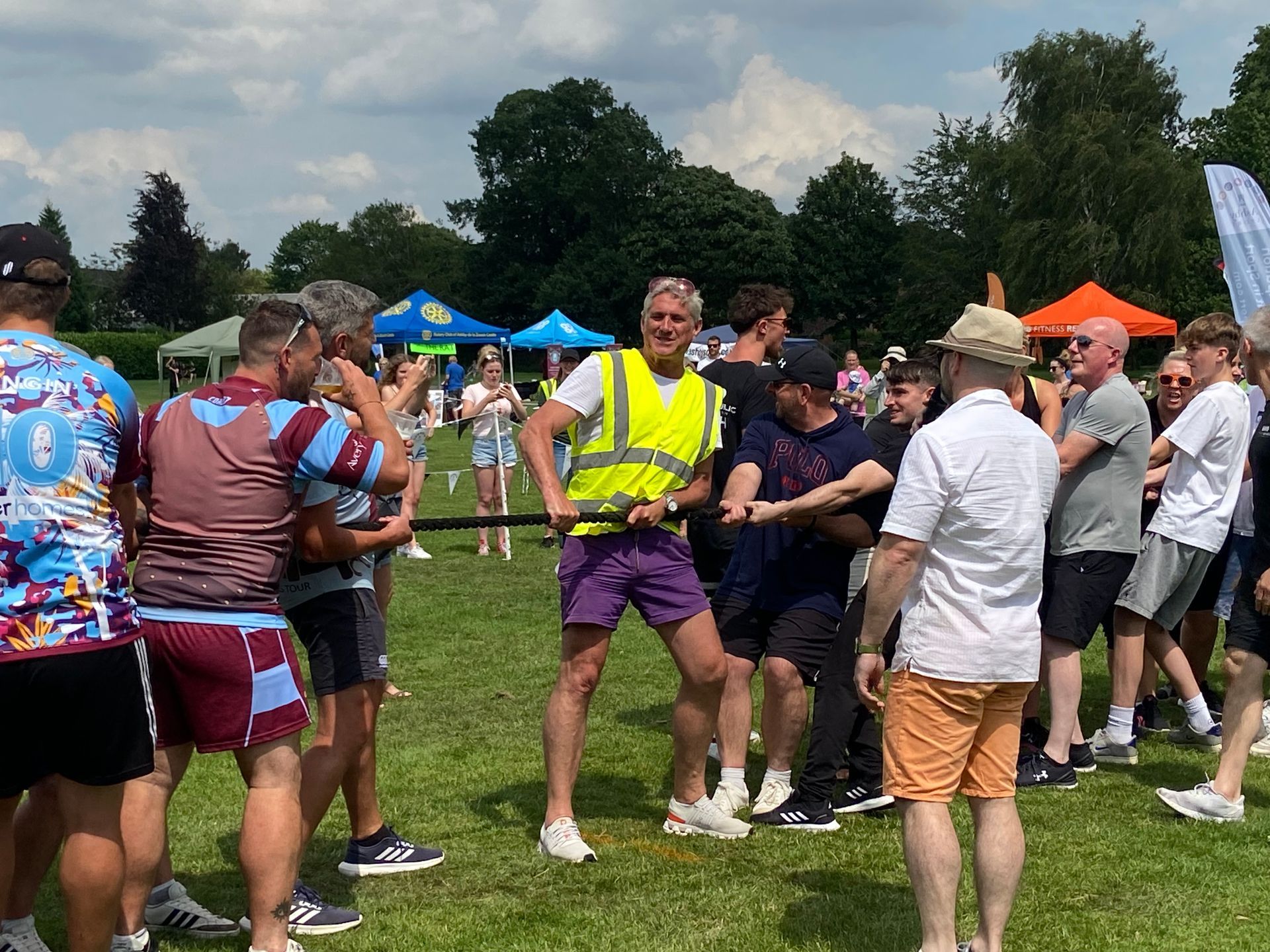 A group of people are standing in a grassy field.