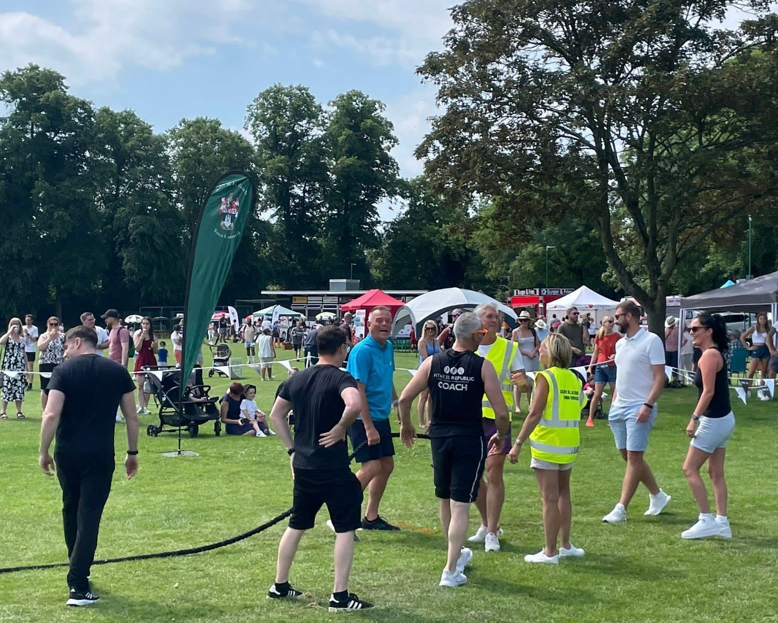 A group of people are standing in a grassy field.