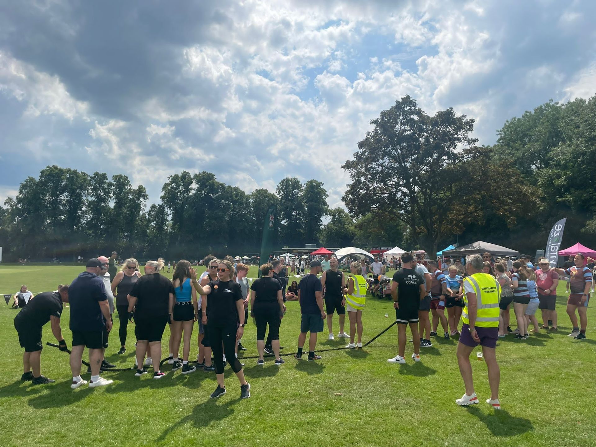 A group of people are standing in a field.