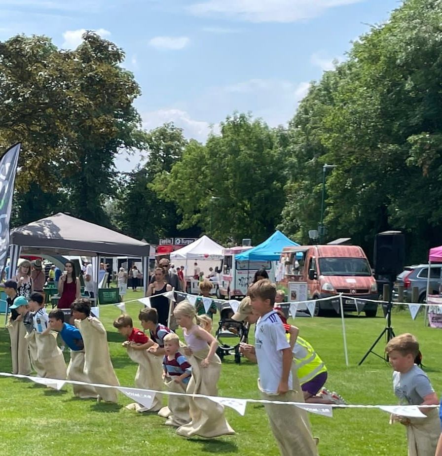 A group of children are playing a game in a field