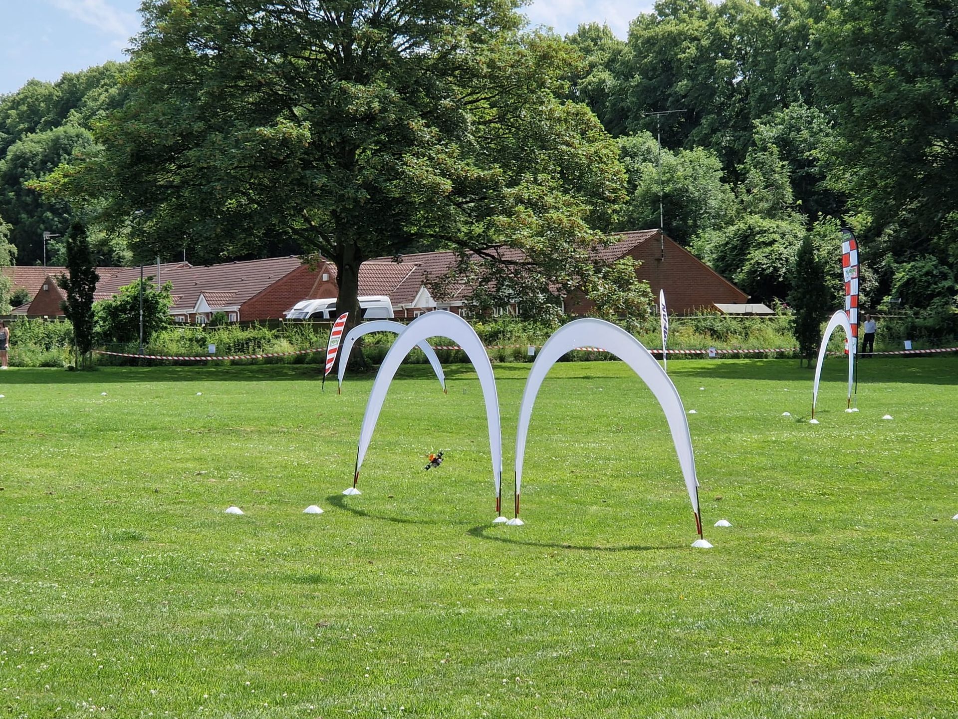 A field with a few arches in it and trees in the background