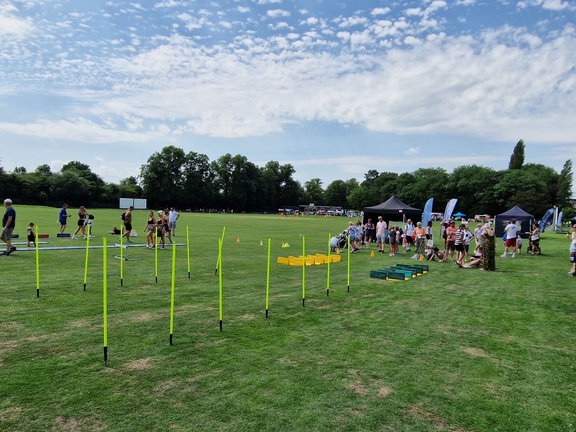 A group of people are standing in a grassy field.