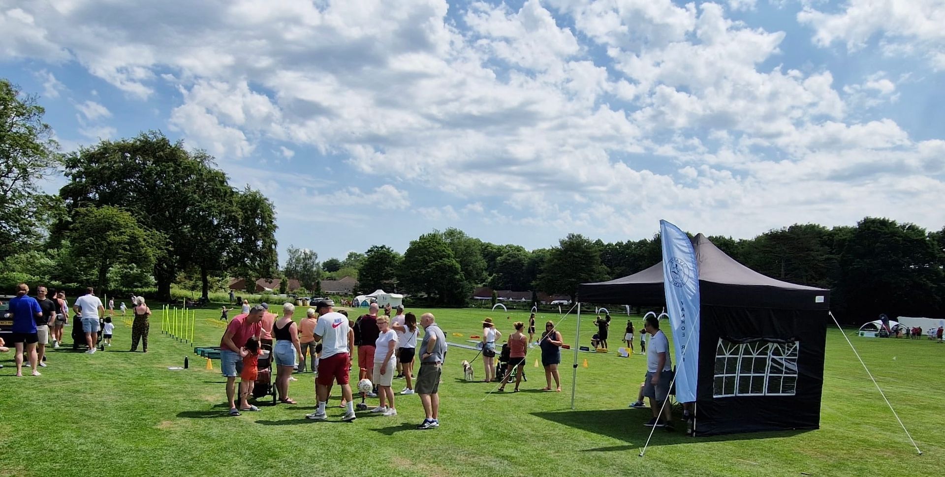 A group of people are standing in a grassy field.