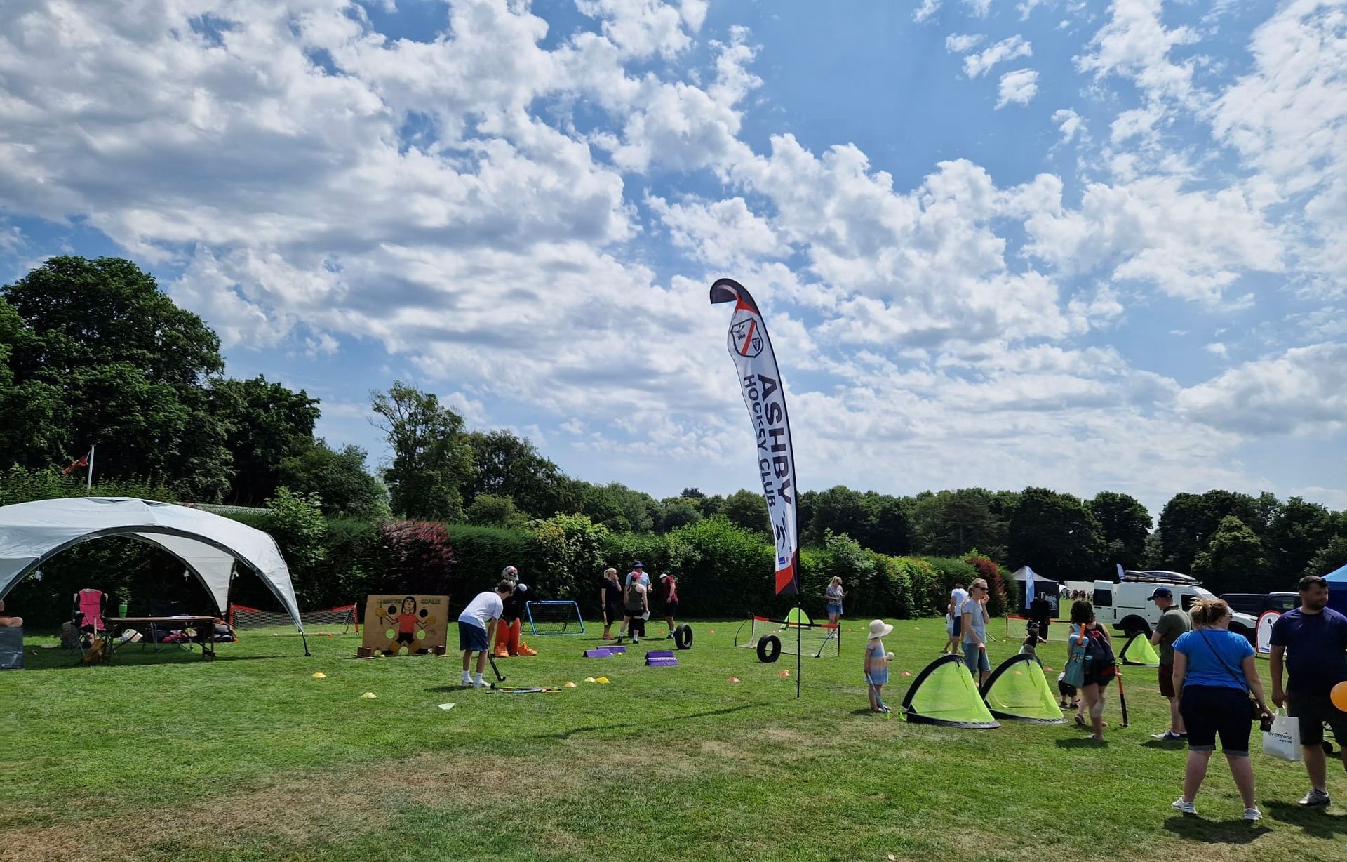 A group of people are standing in a grassy field.
