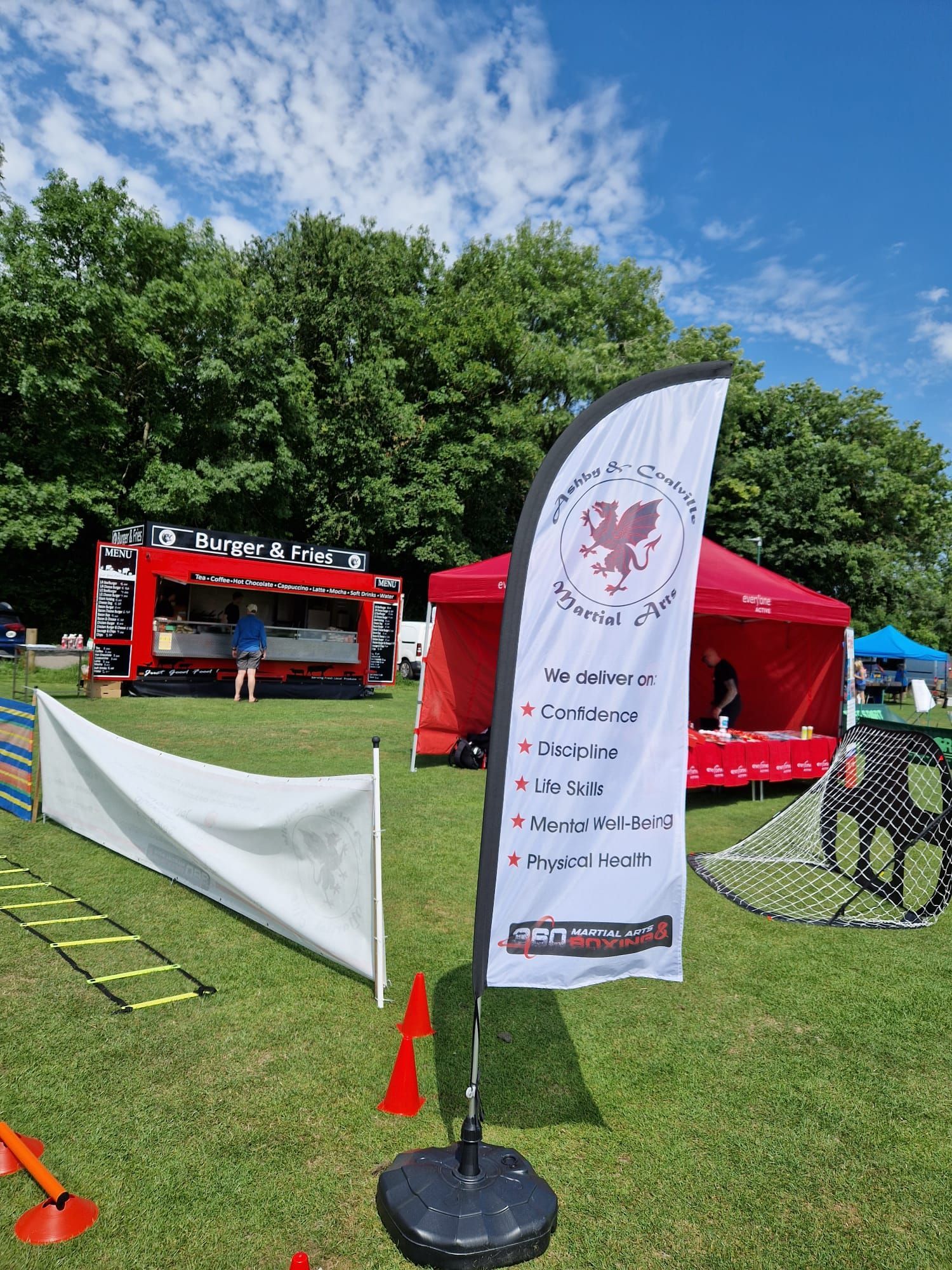 A large flag is sitting in the middle of a grassy field.