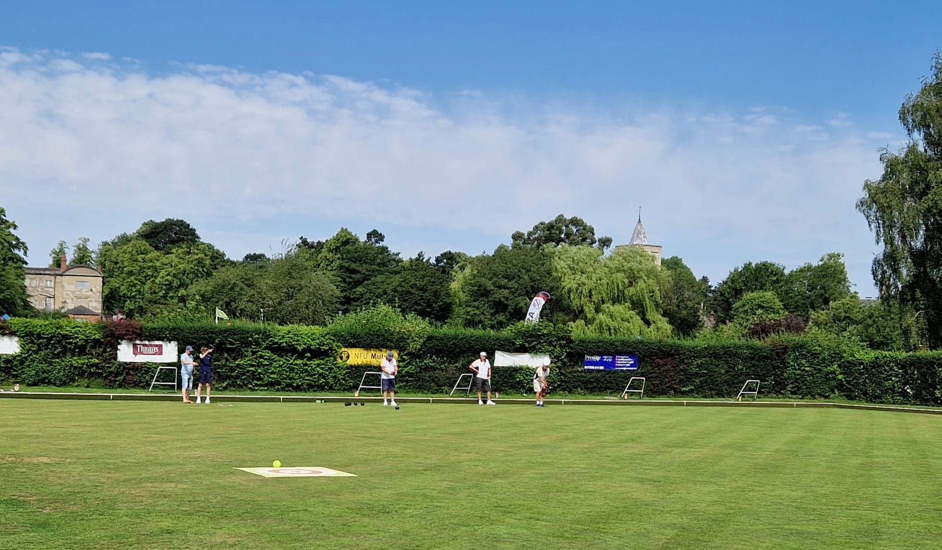 A group of people are playing frisbee in a park on a sunny day
