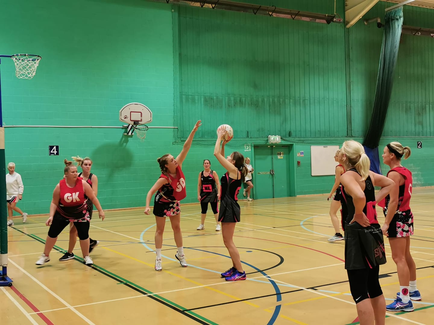 A group of women are playing a game of netball