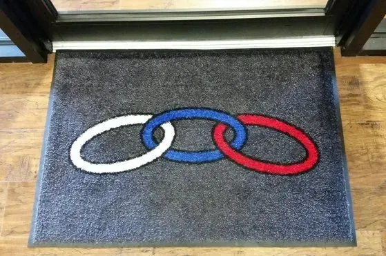 A door mat with three rings painted on it
