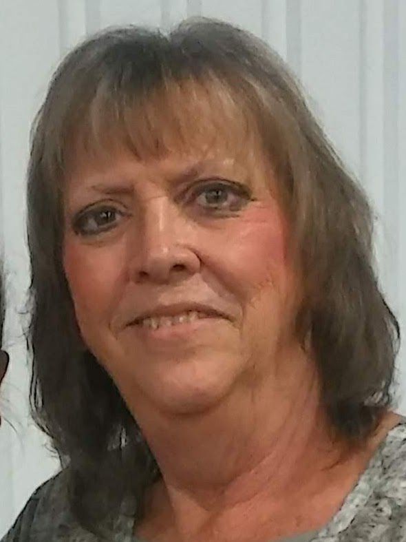 A close up of a woman 's face with a smile on her face.